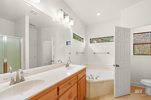 bathroom with a wealth of natural light, visible vents, a sink, and toilet