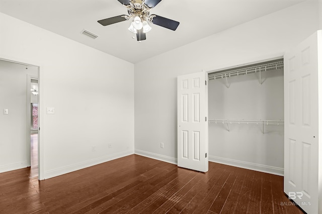 unfurnished bedroom featuring a closet, visible vents, a ceiling fan, baseboards, and hardwood / wood-style flooring