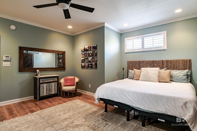 bedroom with hardwood / wood-style flooring, ceiling fan, and ornamental molding