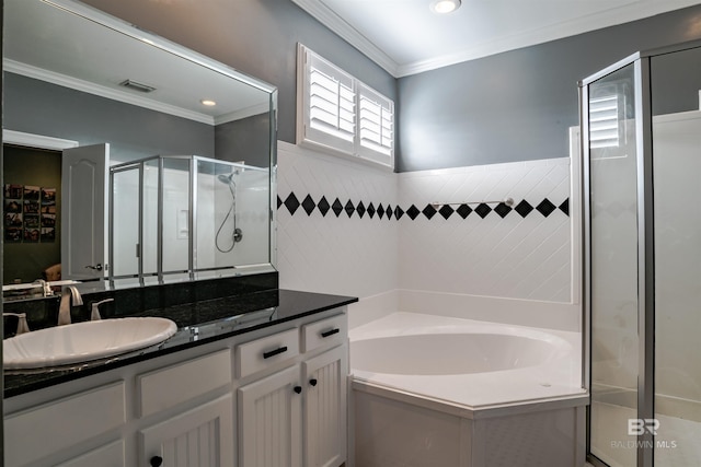 bathroom with crown molding, vanity, plus walk in shower, and tile walls