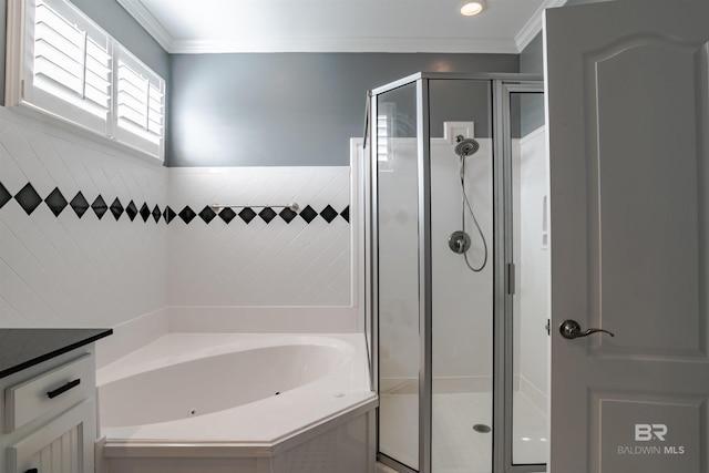 bathroom featuring tile walls, vanity, ornamental molding, and independent shower and bath