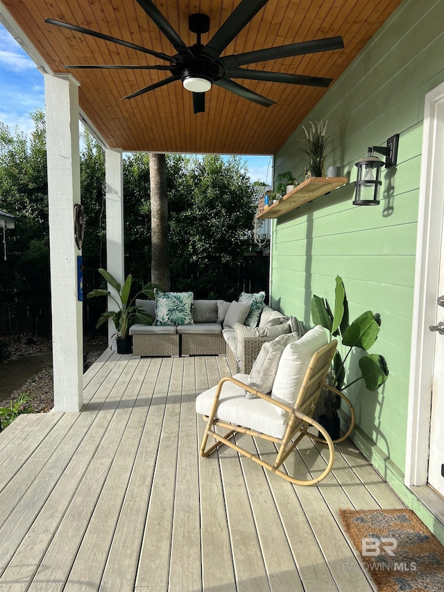 wooden terrace featuring ceiling fan and an outdoor hangout area