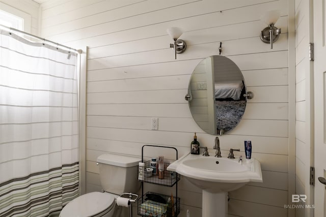 bathroom featuring walk in shower and toilet