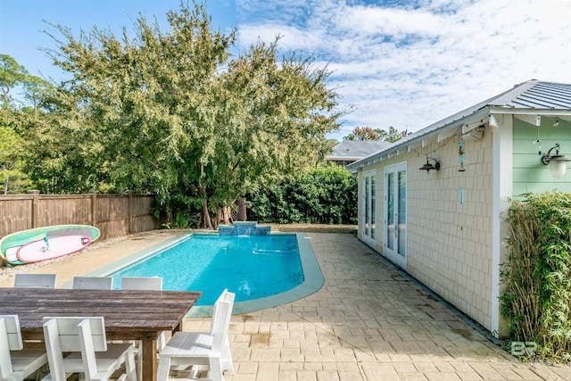 view of swimming pool with french doors, pool water feature, and a patio area