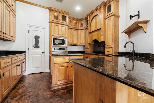 kitchen featuring sink, stainless steel oven, built in microwave, and dark stone countertops