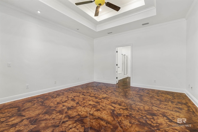 unfurnished room with ceiling fan, a raised ceiling, and ornamental molding