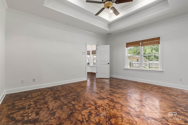 spare room with ceiling fan, a raised ceiling, and crown molding