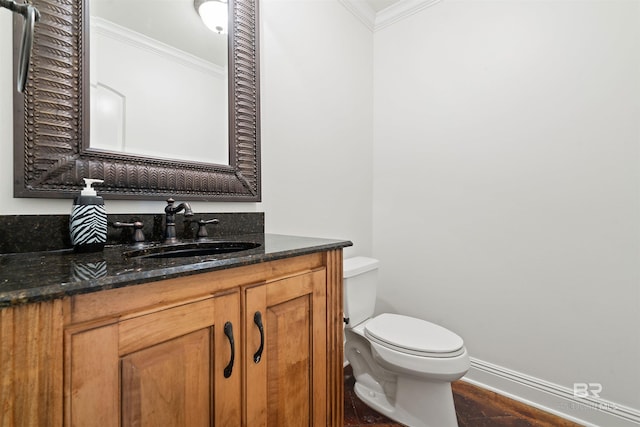 bathroom featuring vanity, toilet, and crown molding