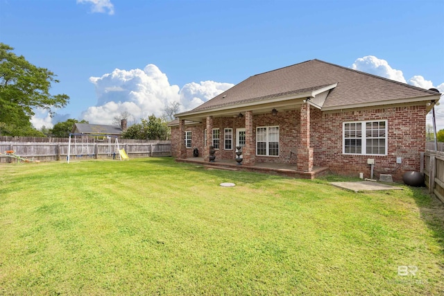 back of property featuring a patio, a playground, and a yard