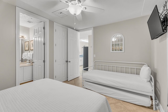 27284 Gulf Rd Unit 711, Orange Beach, AL 36561 - bedroom featuring light tile patterned flooring, connected bathroom, and a ceiling fan