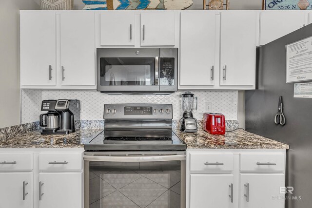 27284 Gulf Rd Unit 711, Orange Beach, AL 36561 - kitchen featuring stainless steel appliances, white cabinets, and backsplash