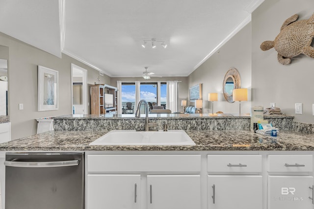 27284 Gulf Rd Unit 711, Orange Beach, AL 36561 - kitchen with stainless steel dishwasher, a sink, a ceiling fan, white cabinetry, and dark stone counters