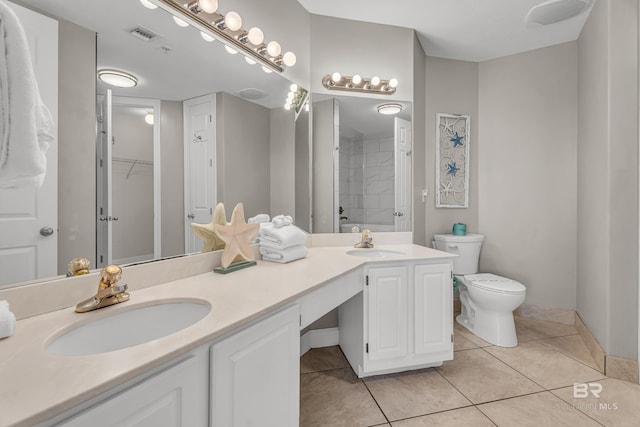27284 Gulf Rd Unit 711, Orange Beach, AL 36561 - full bathroom featuring a shower, toilet, tile patterned floors, and double vanity