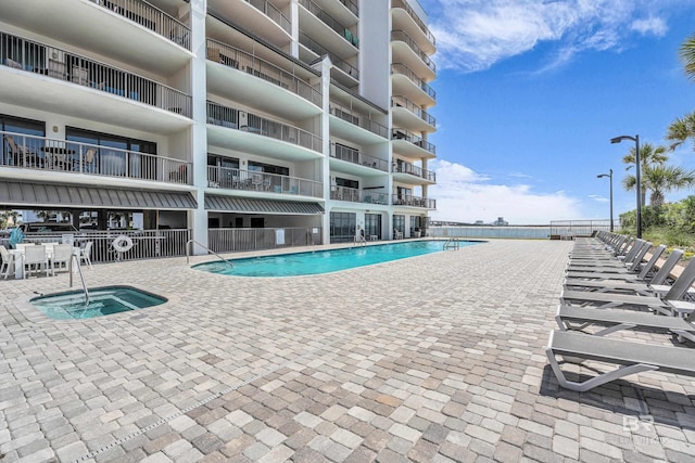 27284 Gulf Rd Unit 711, Orange Beach, AL 36561 - community pool with a patio area, a hot tub, and fence