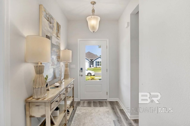 13440 Antler Hill Rd, Spanish Fort, AL 36527 - doorway to outside featuring wood finished floors and baseboards