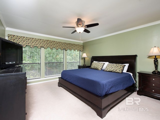 carpeted bedroom featuring ceiling fan and ornamental molding