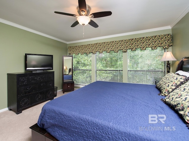 carpeted bedroom featuring crown molding and ceiling fan