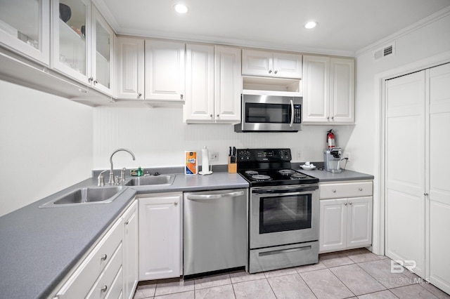 kitchen with stainless steel appliances, white cabinetry, sink, and crown molding