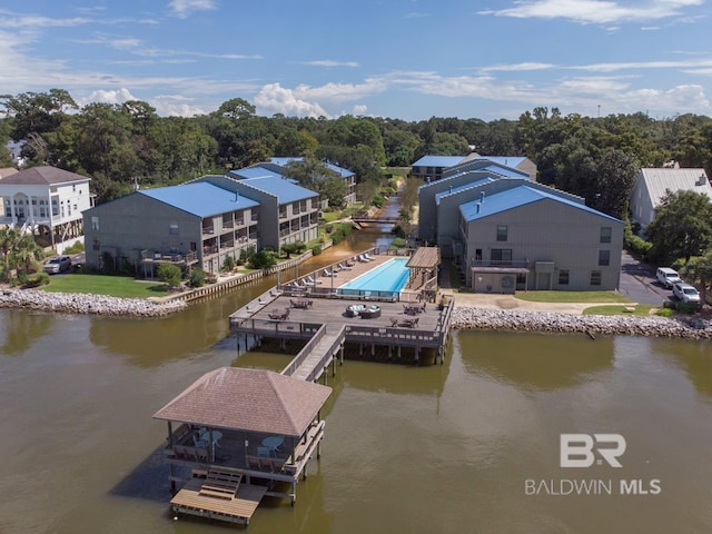 dock area with a lawn and a water view