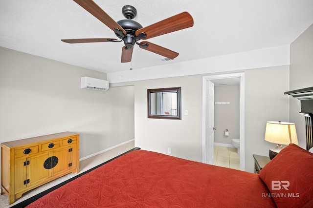 bedroom with ceiling fan, ensuite bathroom, and a wall unit AC