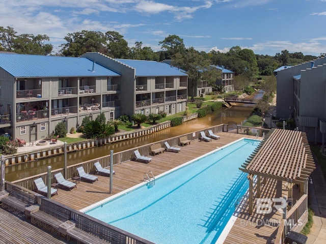 view of swimming pool with a water view