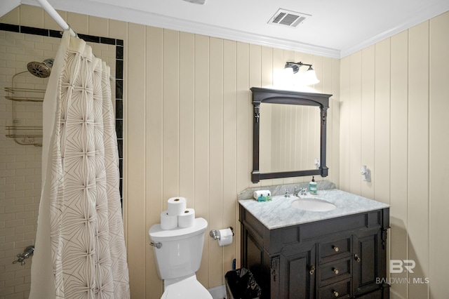 bathroom featuring vanity, wood walls, walk in shower, crown molding, and toilet