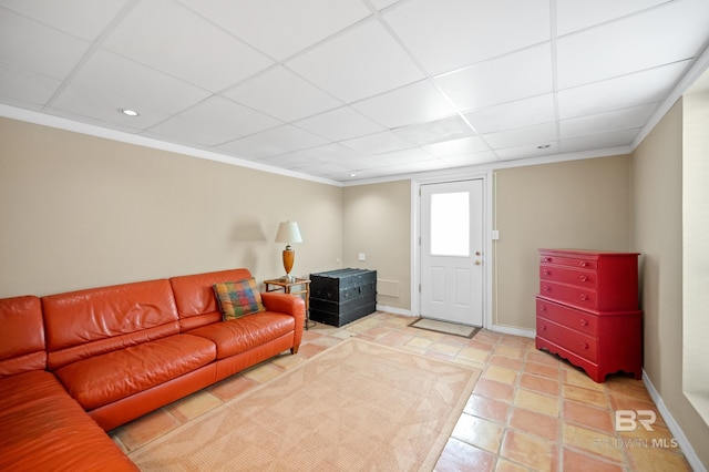 tiled living room featuring a paneled ceiling and crown molding