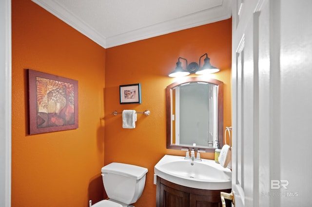 bathroom featuring ornamental molding, vanity, and toilet