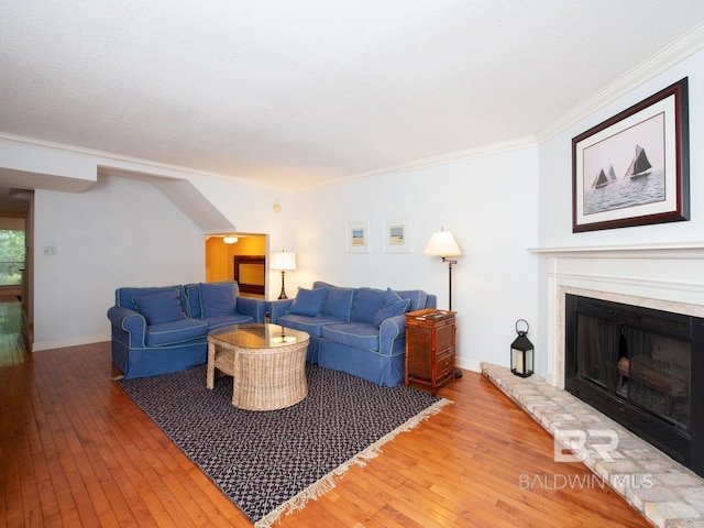 living room with ornamental molding and wood-type flooring