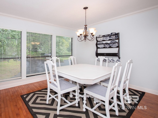 dining area with ornamental molding, a wealth of natural light, and wood-type flooring