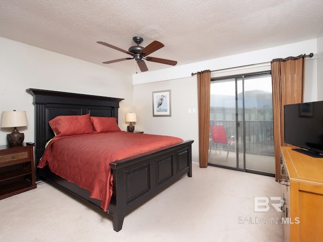 carpeted bedroom featuring ceiling fan, access to outside, and a textured ceiling