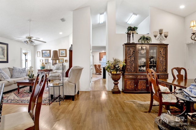 living room with high vaulted ceiling, light hardwood / wood-style flooring, and ceiling fan