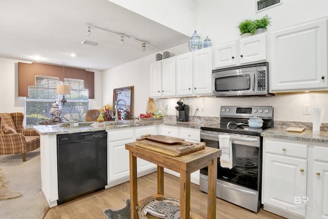 kitchen featuring decorative light fixtures, white cabinetry, stainless steel appliances, and kitchen peninsula