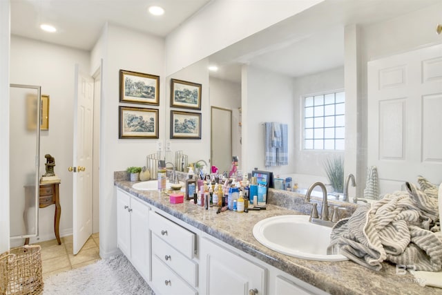 bathroom with tile patterned floors, vanity, and walk in shower