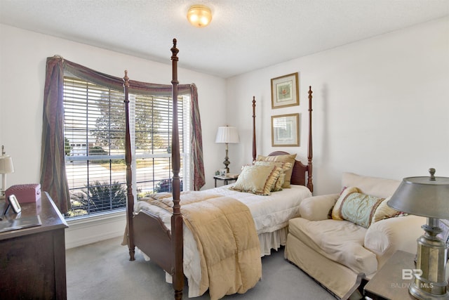 bedroom featuring light carpet, a textured ceiling, and multiple windows