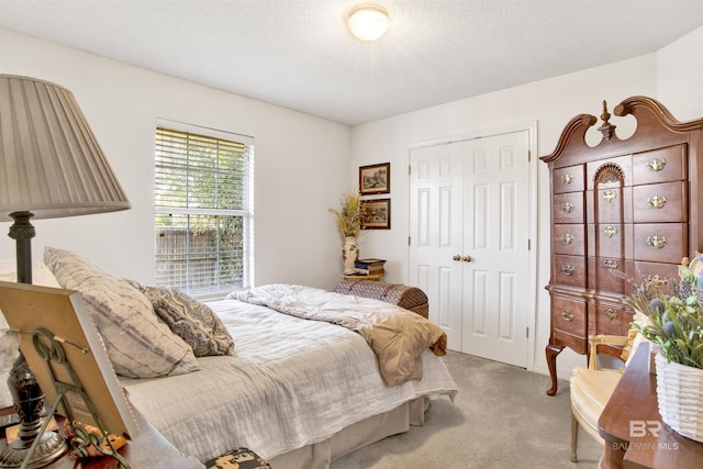 bedroom featuring light carpet and a closet