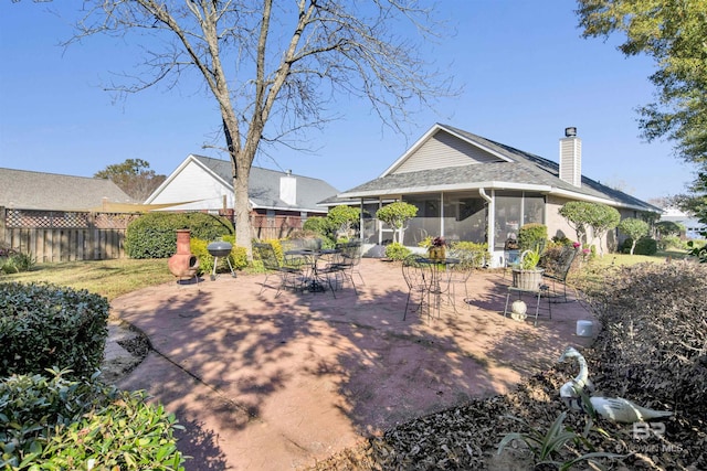 view of yard featuring a sunroom and a patio