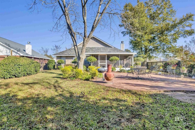 view of yard with a sunroom and a patio area