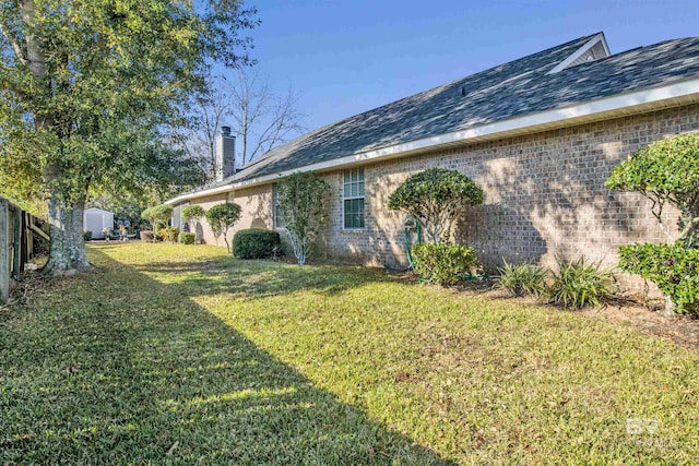 view of side of home featuring a yard