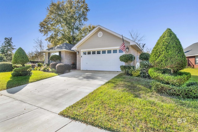 view of front of property featuring a garage and a front lawn