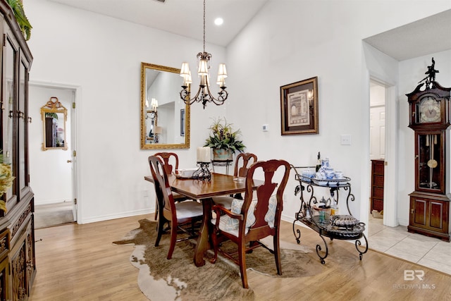 dining area featuring light hardwood / wood-style floors and an inviting chandelier