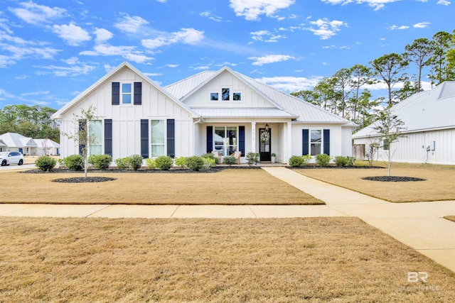 modern inspired farmhouse with a porch and a front lawn