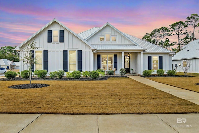 modern farmhouse featuring a yard