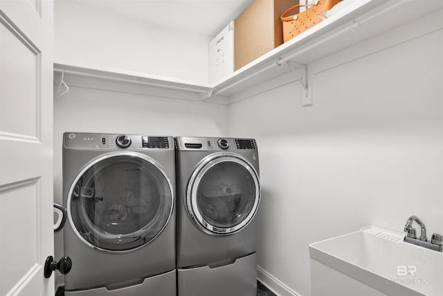 laundry area featuring independent washer and dryer and sink