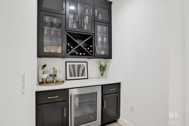 bar featuring wine cooler and backsplash