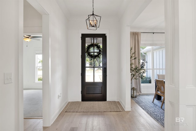 entrance foyer with a notable chandelier and light wood-type flooring