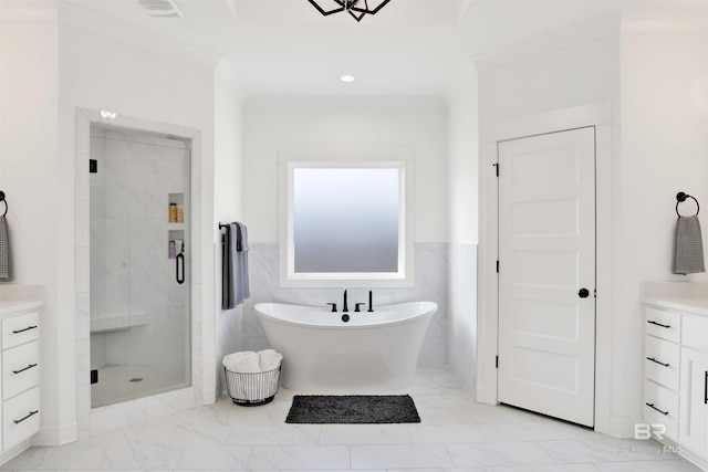 bathroom with vanity, independent shower and bath, and tile walls