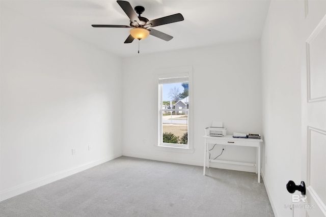 carpeted spare room with ceiling fan