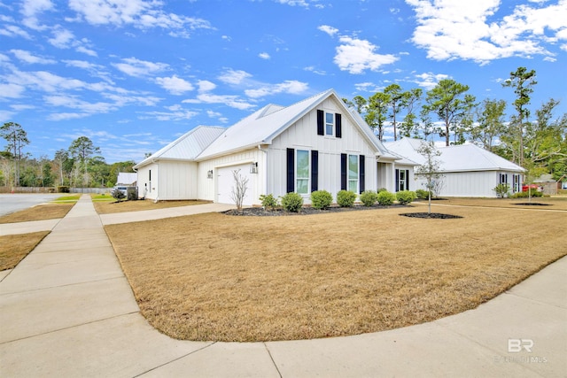 view of front of home featuring a garage and a front lawn