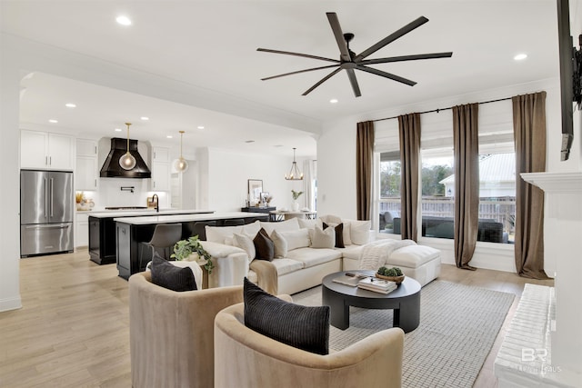 living room with ceiling fan and light hardwood / wood-style floors